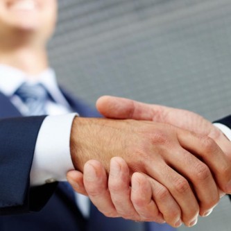 Two businessman shaking hands greeting each other Two businessman shaking hands greeting each other